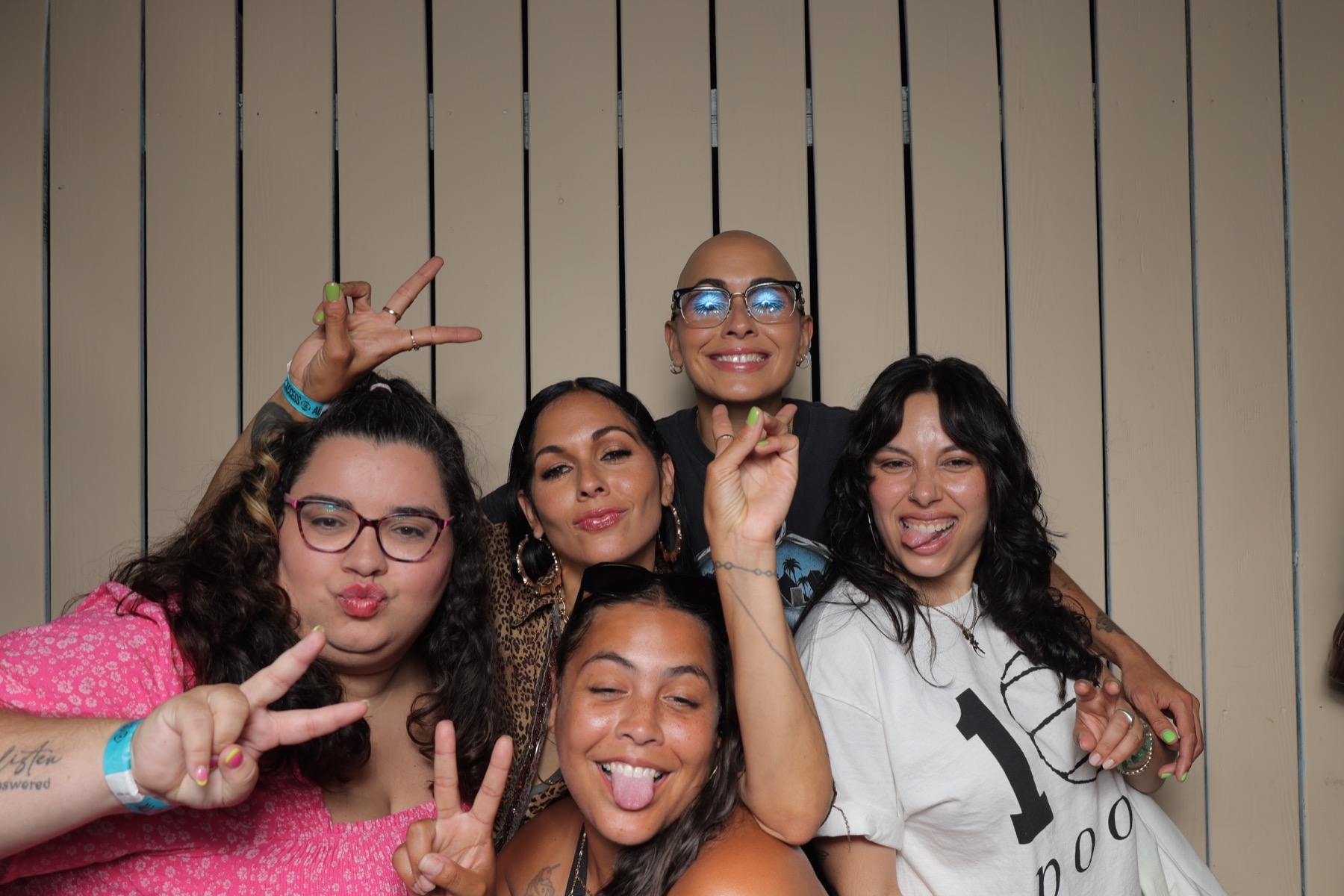 Guests throwing peace signs and smiling in the photobooth