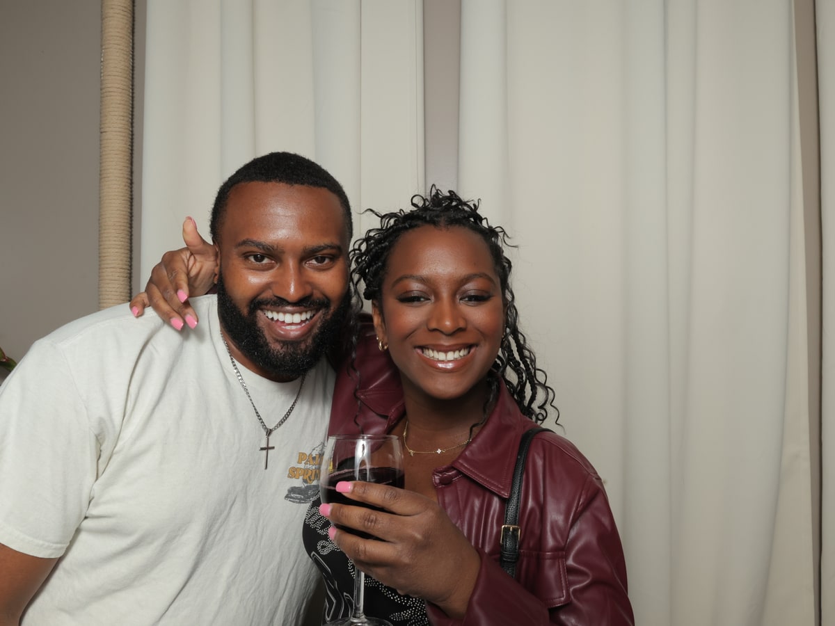 Two guests smiling in a classic photobooth print